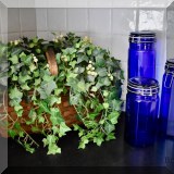 D30. Basket of faux ivy and glass canisters. 